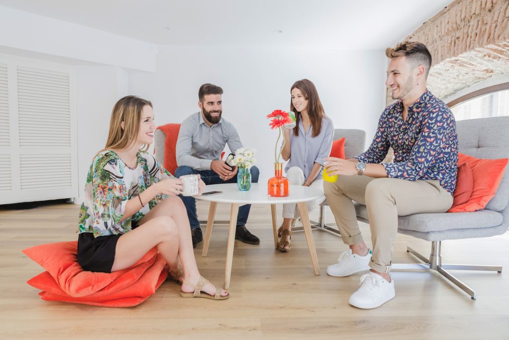 Group of friends talking and laughing, reflecting strong emotional health outside marriage