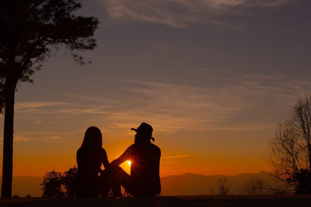 Married couple standing united with hopeful future in sight.