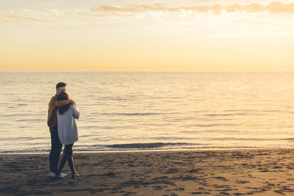 Couple holding each other at dawn-symbolizing presence and loving urgency