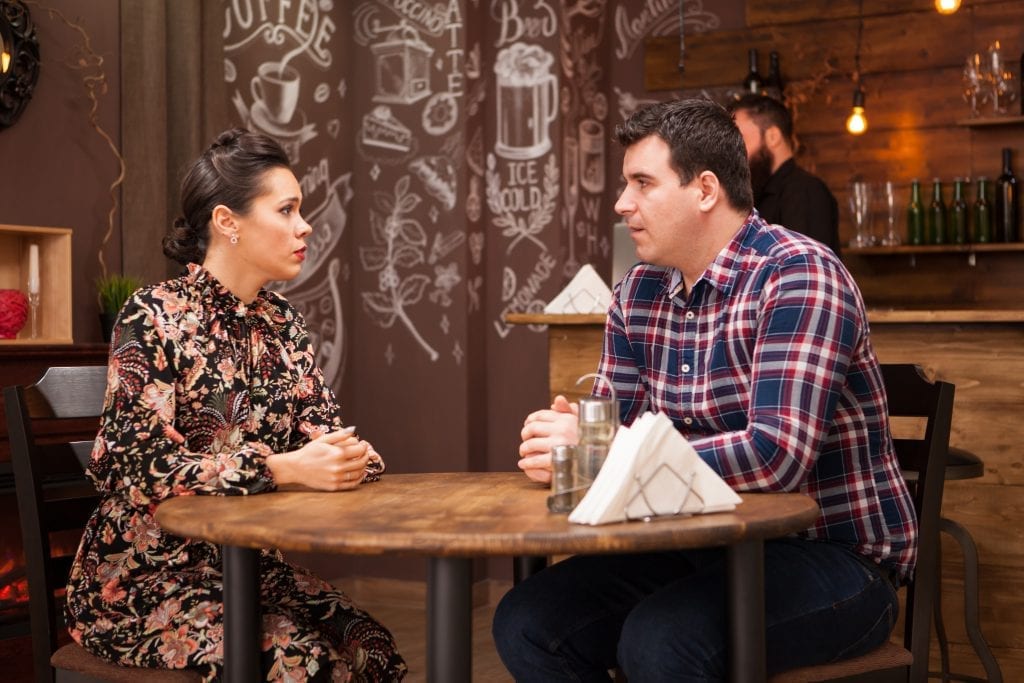 Spouses engaging in a vulnerable conversation, reflecting the courage to try again with honesty and boundaries. 