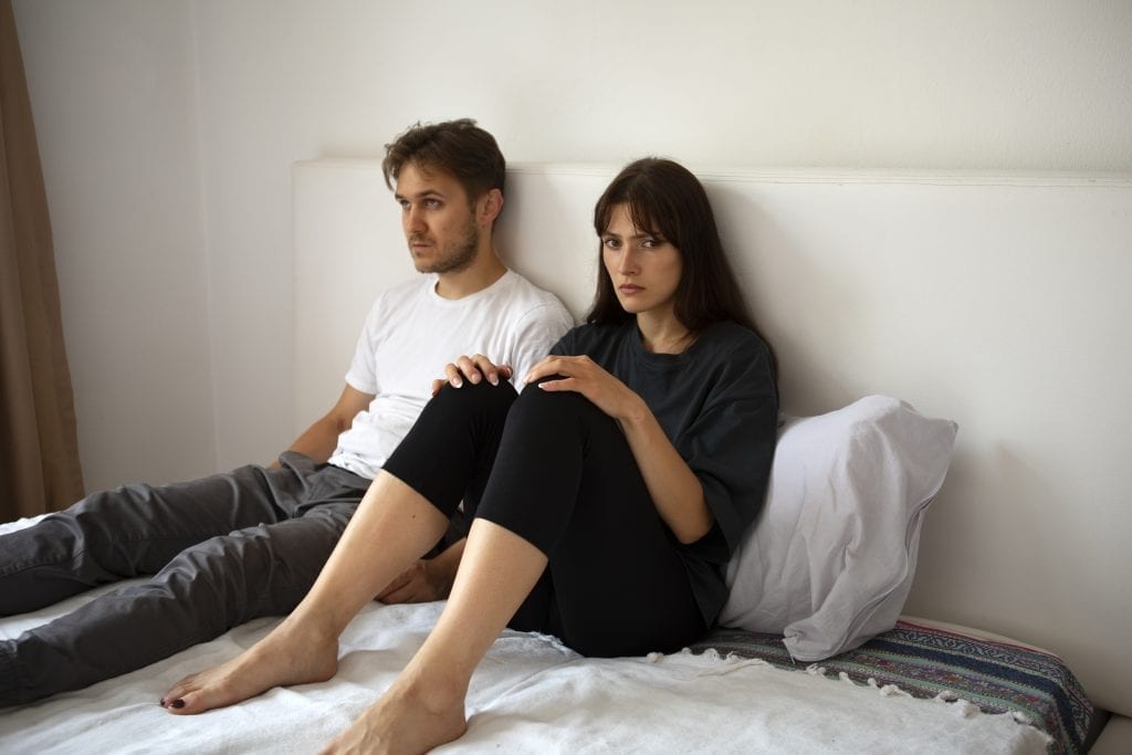 Spouses sharing a moment of quiet vulnerability, symbolizing emotional honesty in marriage.