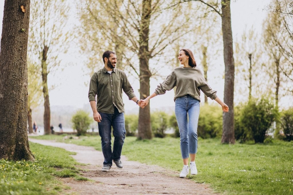 Happy couple reconnecting outdoors through intentional conversation