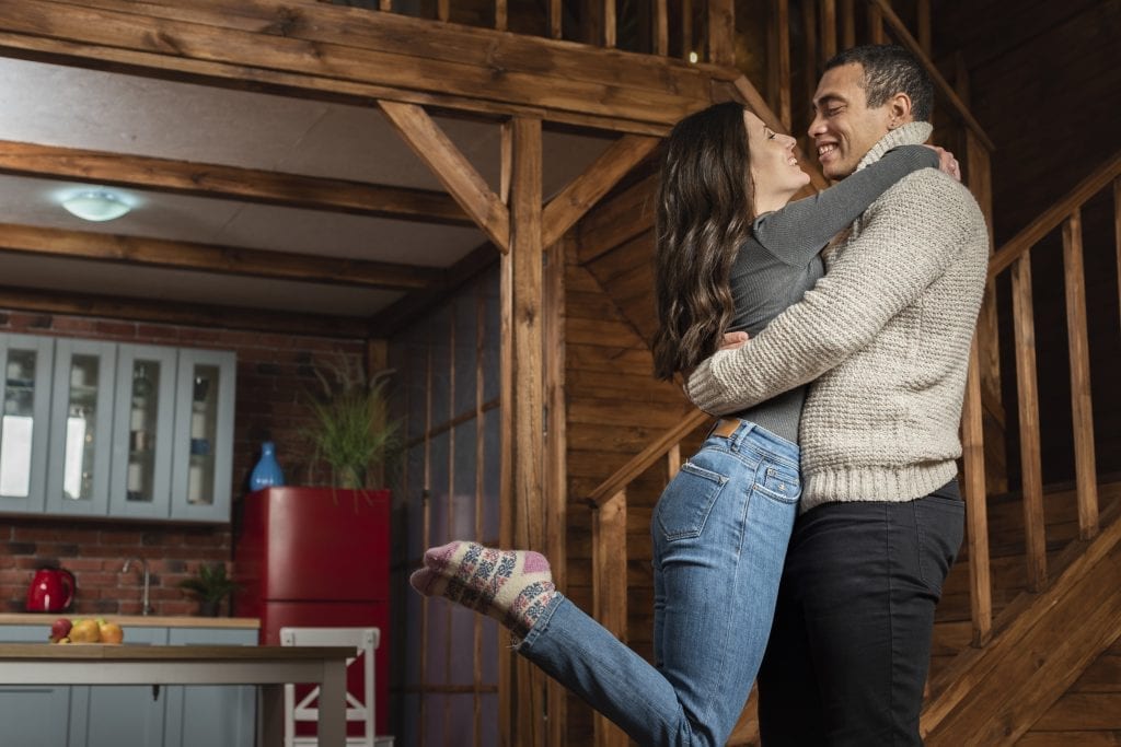 Married couple greeting each other warmly to build daily connection and prevent fights.