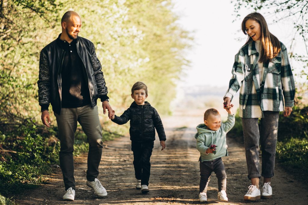 Couple walking together as children lead the way, symbolizing a marriage that models love across generations.