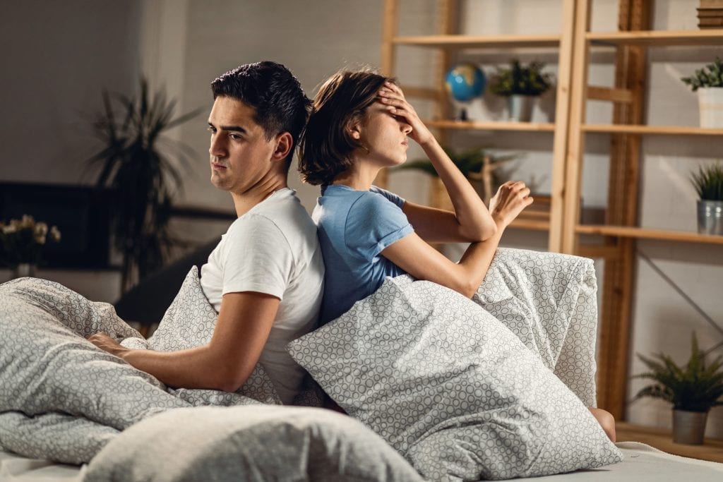 Married couple feeling the pressure of life but choosing to stay present with one another.