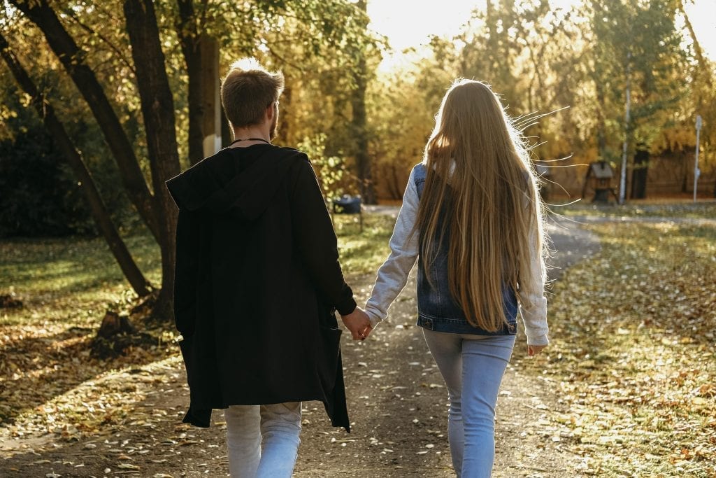 Couple walking peacefully through a quiet park, representing intentional margin for connection.