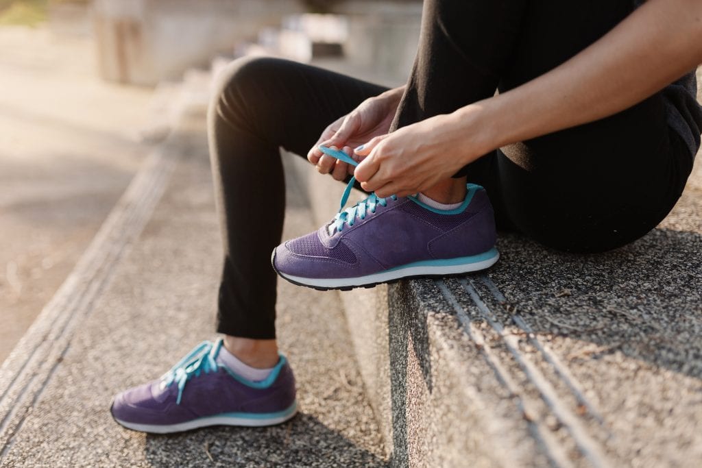 Person preparing for exercise, symbolizing the quiet prep work of emotional training in marriage.