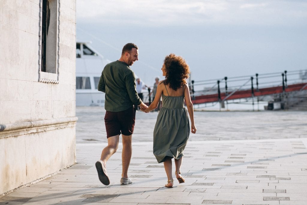 Husband and wife walking together, showing reconnection after handling conflict with care.