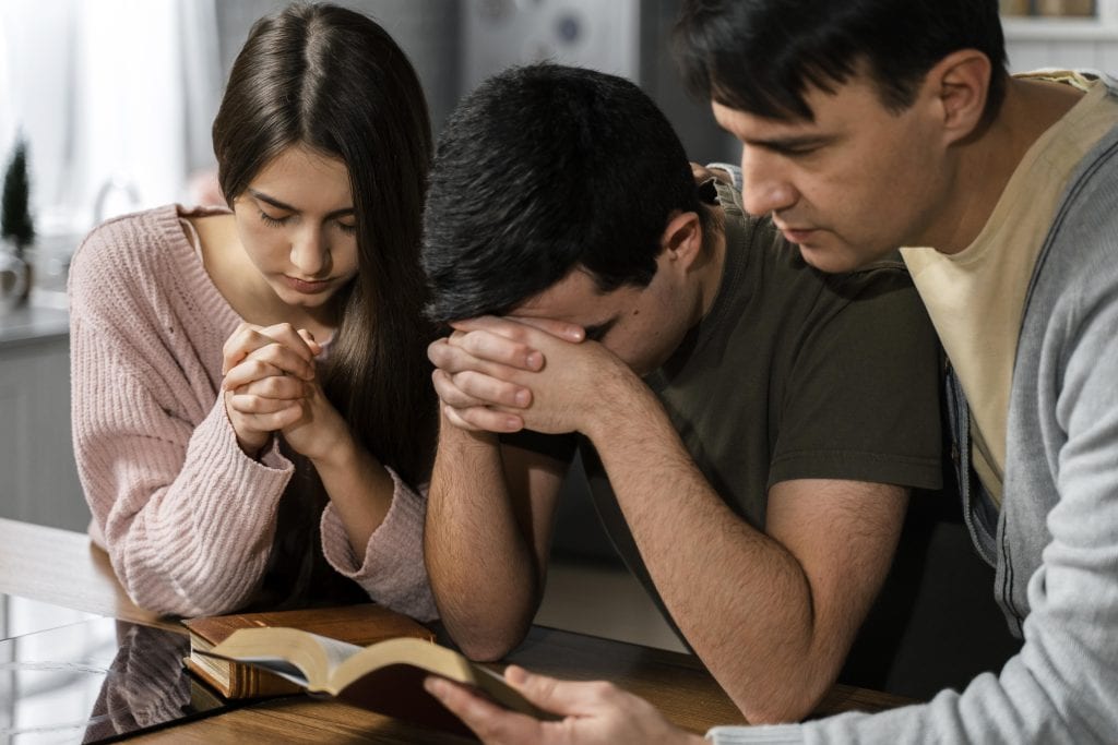 Supportive community lifting up a marriage with positive words and affirmation.