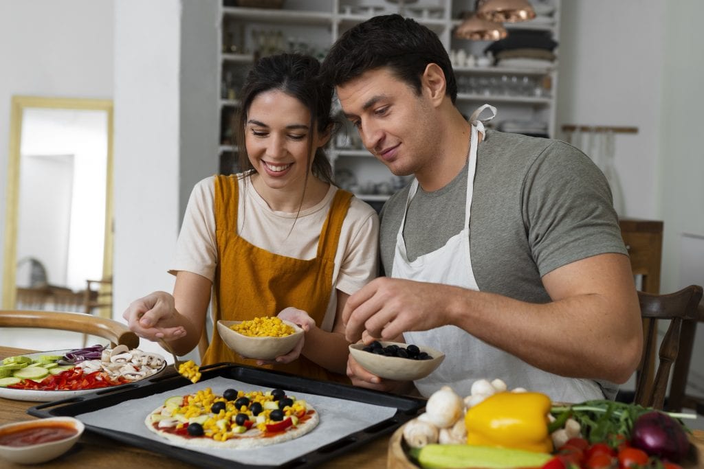 Married couple preparing a healthy meal, representing shared lifestyle changes.