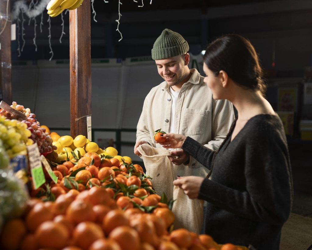 Husband and wife choosing fresh produce together, symbolizing choosing what to consume emotionally in marriage.