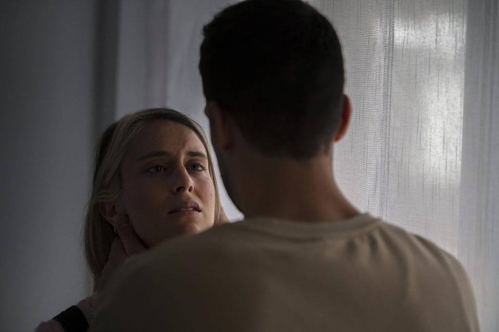 Married couple having a tense conversation, representing personal attacks during arguments.