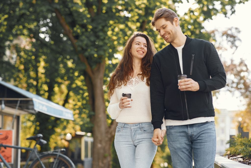 Couple enjoying a sunrise cocoa walk as part of their weekly micro-adventure.