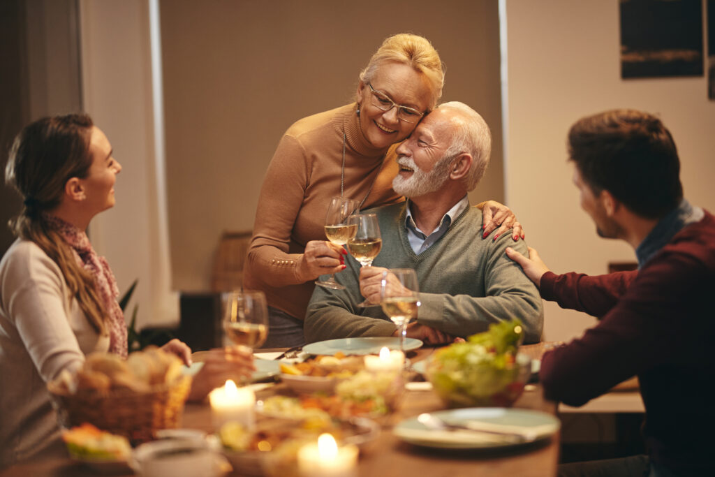 parents and grandparents having a calm discussion at a family dinner table about parenting boundaries