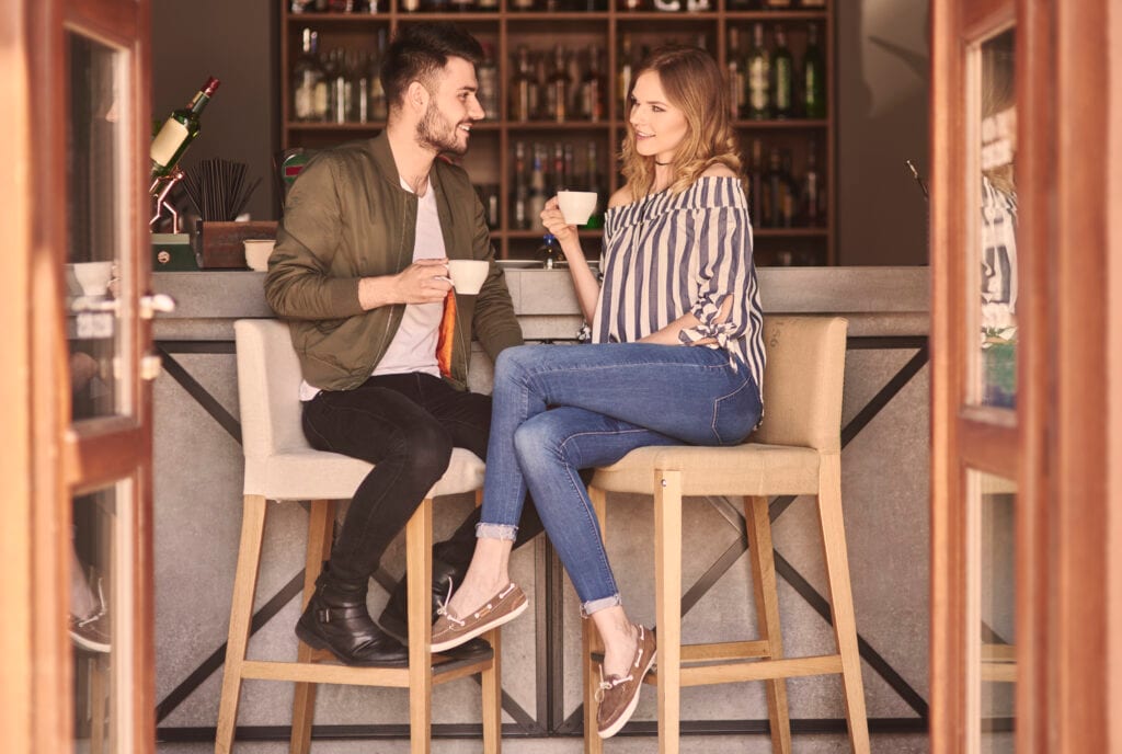 Husband and wife speaking gently and listening attentively, rebuilding connection through honesty.