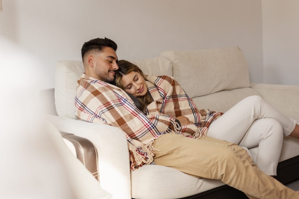 couple sitting closely showing comfort after resolving misunderstanding