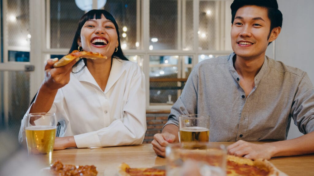 Husband and wife enjoying device-free dinner, celebrating small wins toward presence.