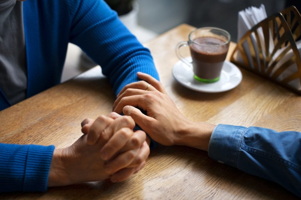 clasped hands symbolizing trust built through calm understanding