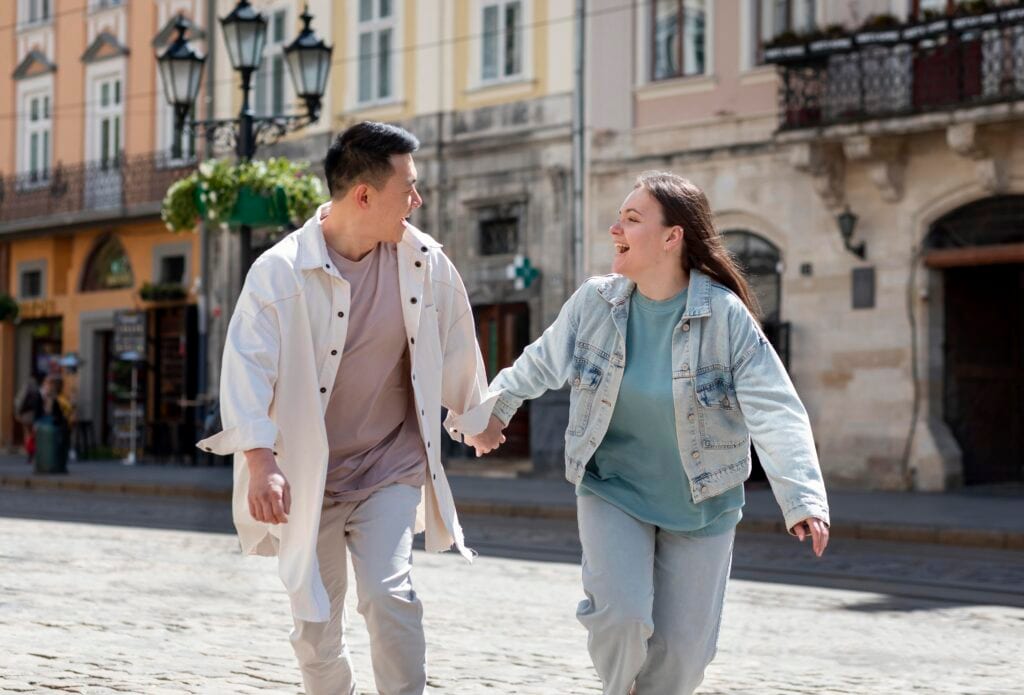Married couple walking joyfully device-free, symbolizing freedom created by gentle boundaries.
