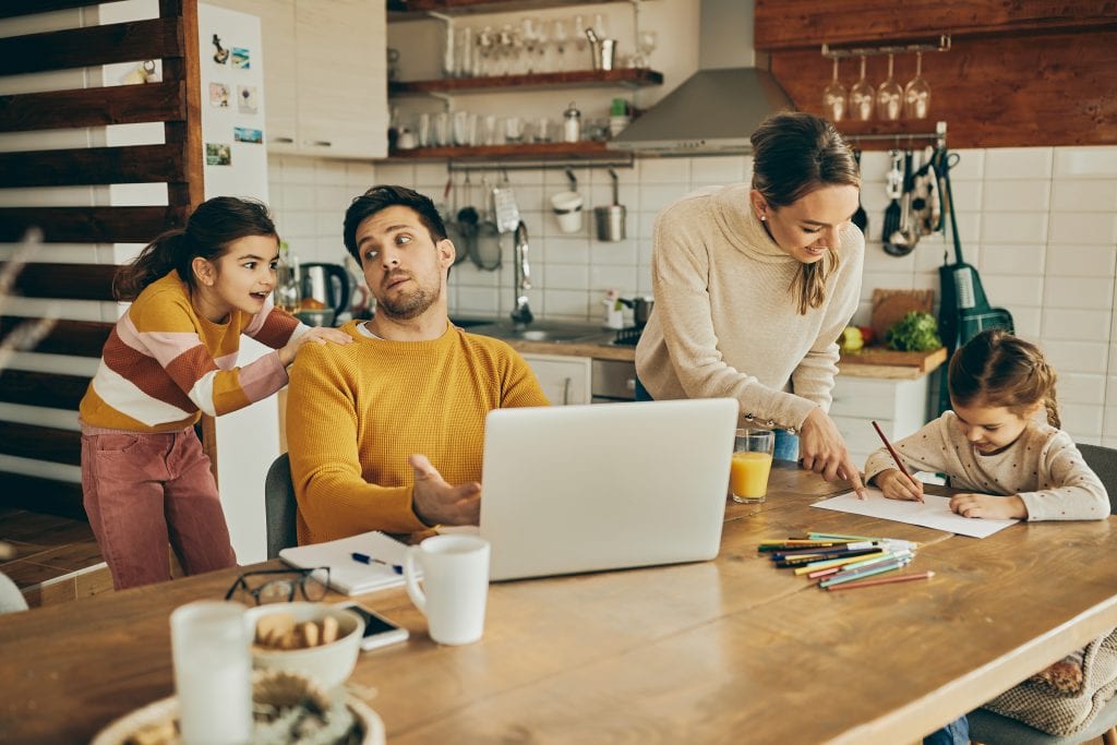 parents and kids having pre-holiday planning huddle writing down family values