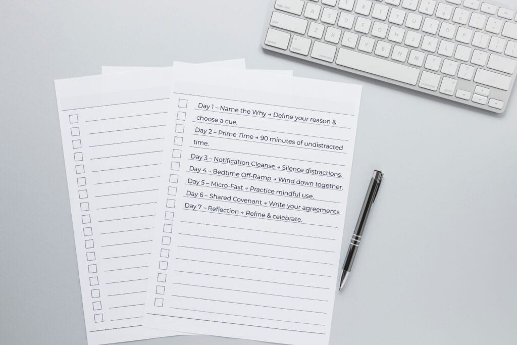 Printable 7-day attention reset checklist with pen and coffee, symbolizing structure and intention.
