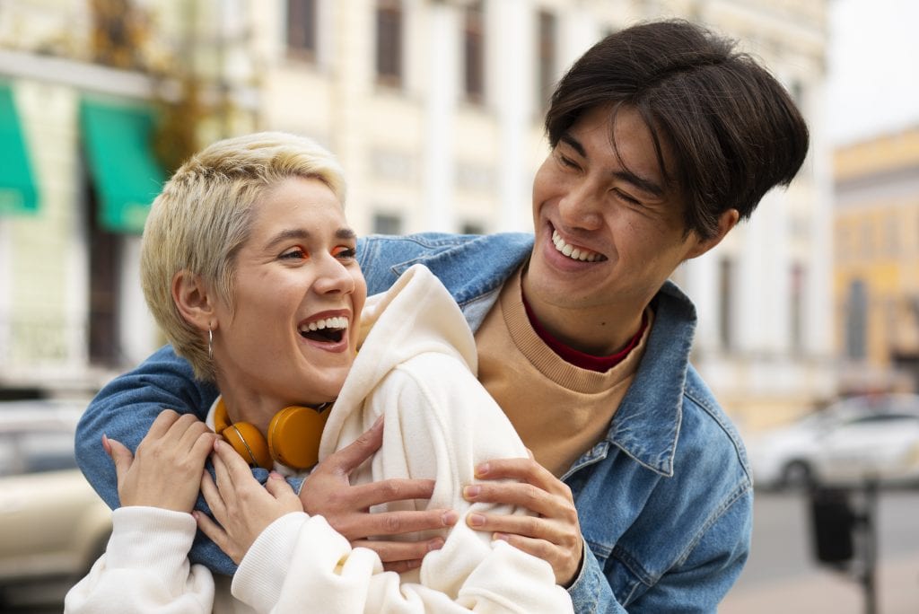 Married couple smiling after overcoming a recurring argument pattern.