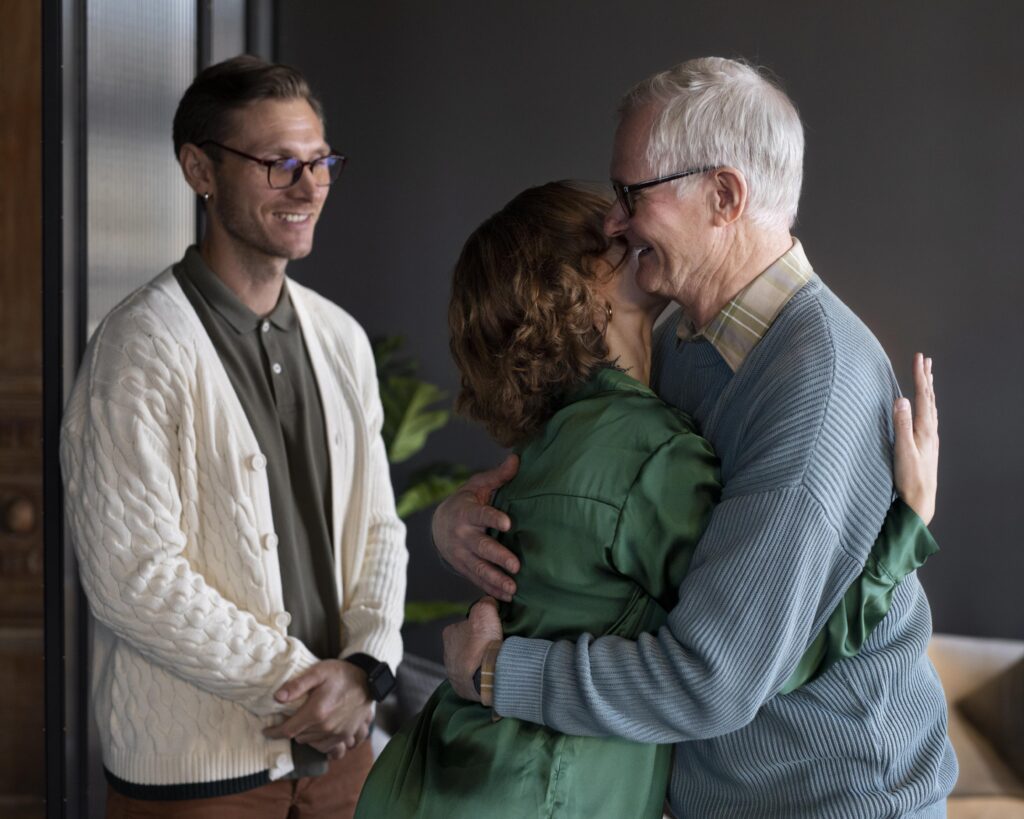 grandparents and parents sharing a gentle hug after a successful visit