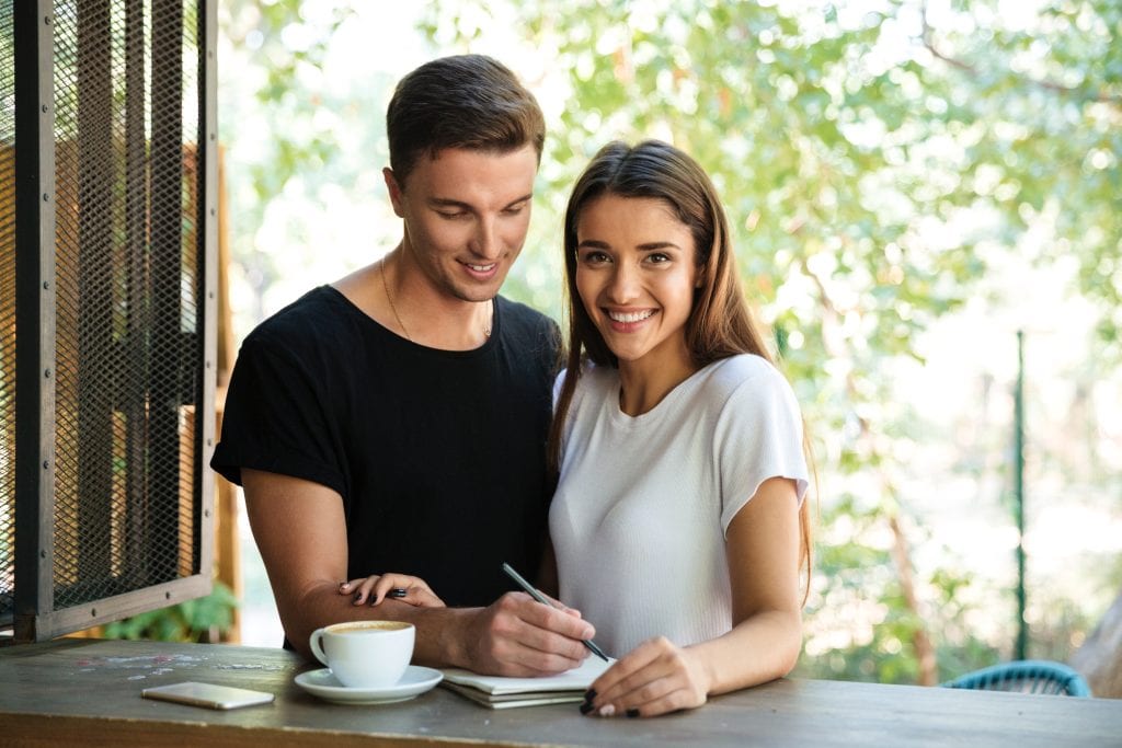 couple celebrating gradual progress using habit audit notes