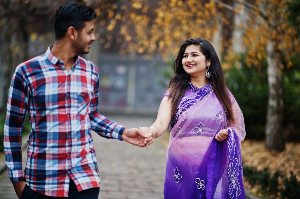 Spouses reconnecting with warmth after a brief phone slip, showing gentle repair without conflict.