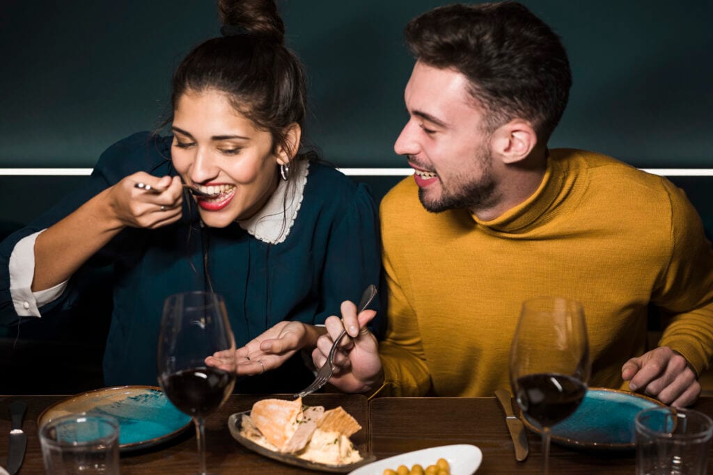 Married couple enjoying dinner device-free, showing a gentle mealtime pause that invites connection.