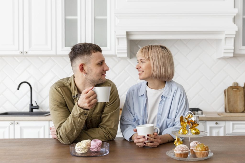 Couple talking over morning coffee symbolizing renewed connection after deferring conflict.