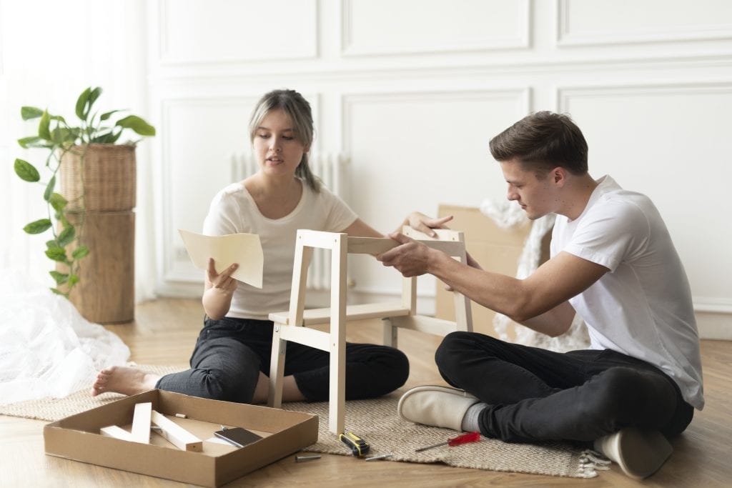 Couple working together on a project symbolizing teamwork and unity.