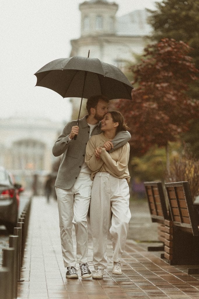 Married couple showing emotional closeness through humor during hard times.