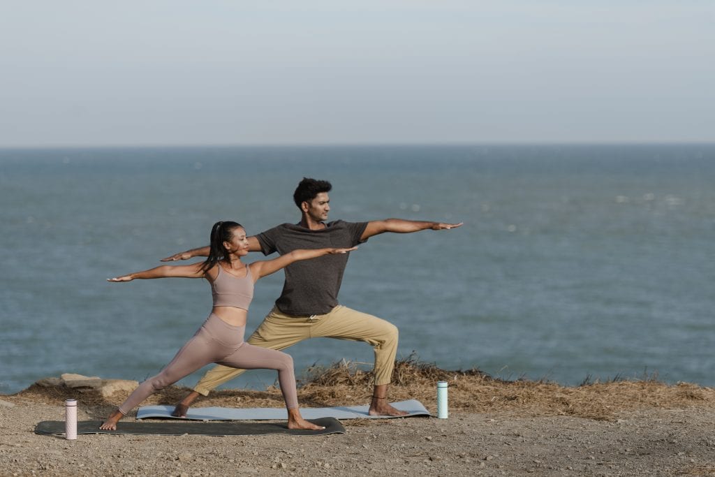 Couple demonstrating flexibility and connection through balance and support.