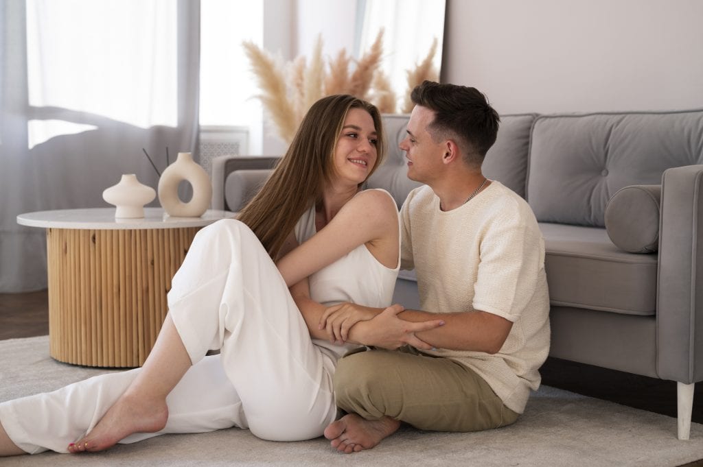 Married couple beginning to reconnect after tension, preparing for laughter again.