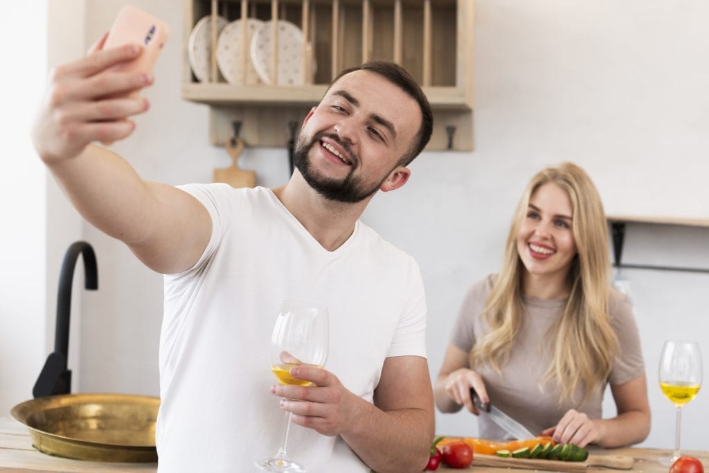 Married couple capturing a lighthearted kitchen moment for their joy file.