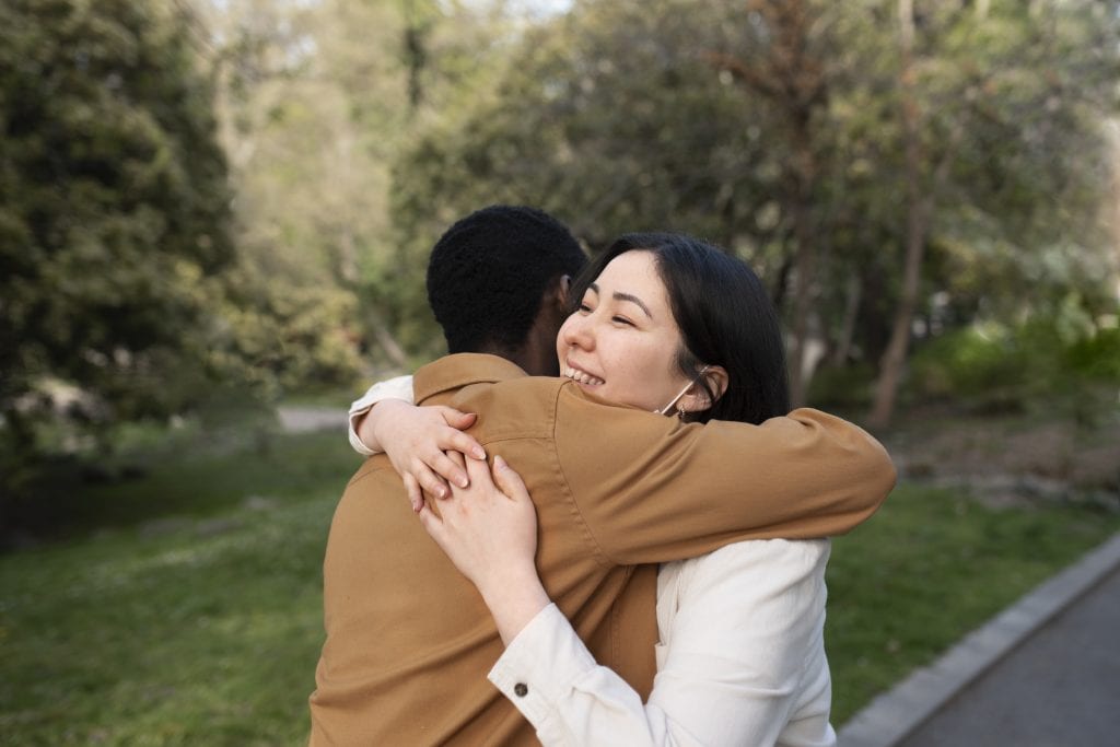 Couple hugging after conflict symbolizing recovery and strength.