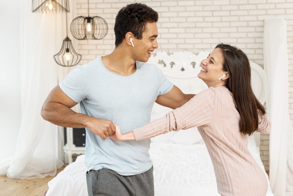 Couple learning a dance representing rehearsal for emotional connection.