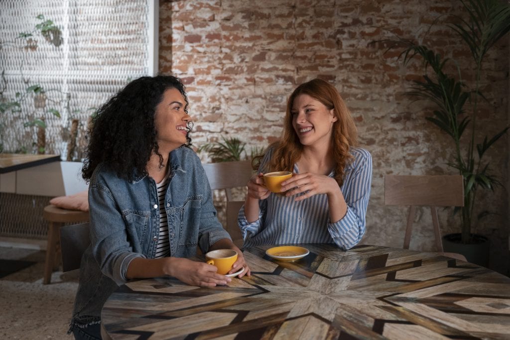 Trusted friends talking over coffee, representing Accountability That Heals, Not Shames in marriage growth.
