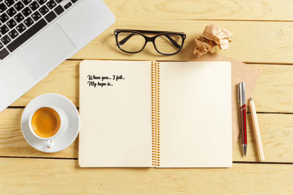Helpful communication prompts written in a notebook to use during weekly check-ins