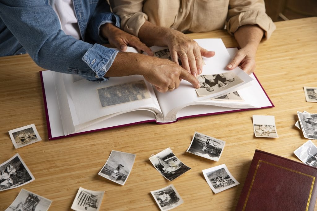 Married partners creating their laughter scrapbook as a shared bonding activity.