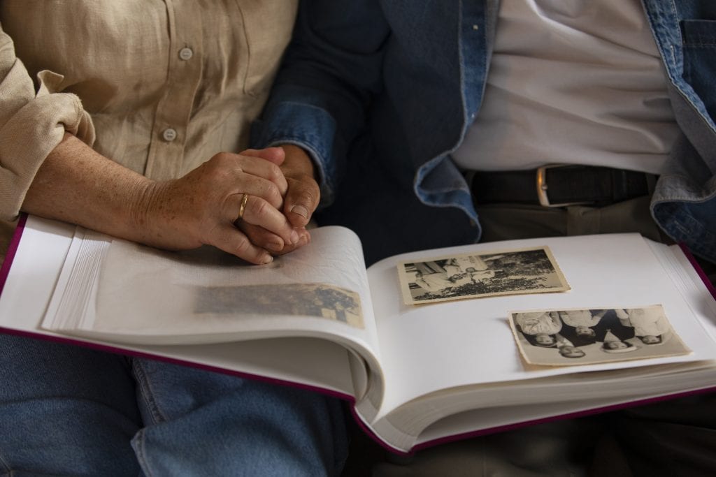 Married partners remembering shared laughter and joyful memories.
