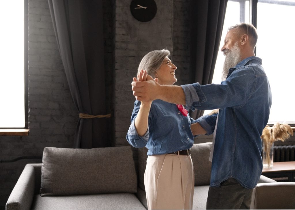 Married couple dancing slowly at home, symbolizing harmony and grace in marital rhythm