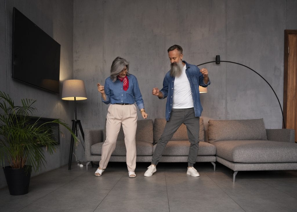 Married couple using a dance-off to bring humor back during conflict.