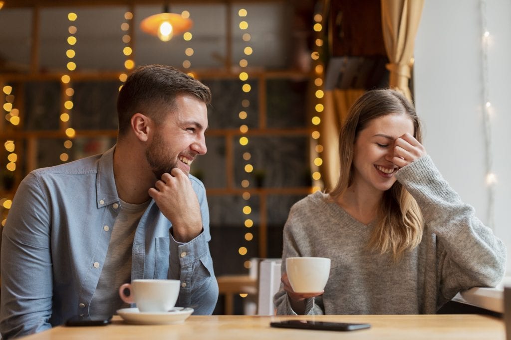 Married couple smiling together after calmly resolving a disagreement through a pause habit