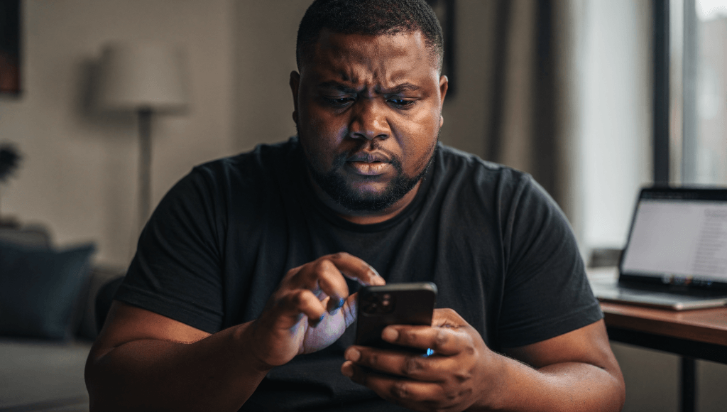 Person holding their phone, hesitating before replying to a message, deciding what to do when compliments get complicated