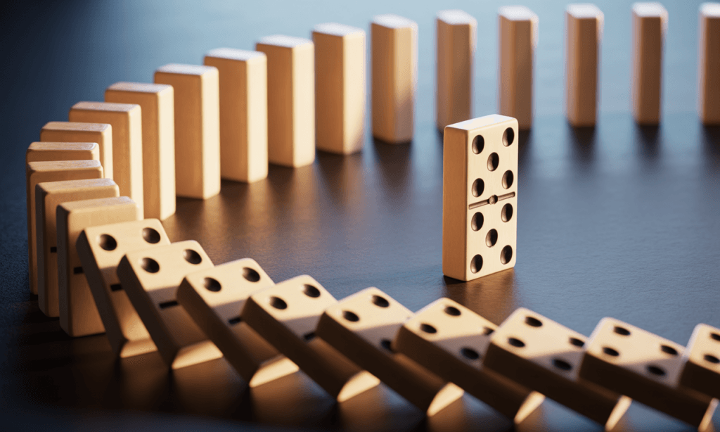 One domino standing upright while others fall, representing choice and agency in marriage