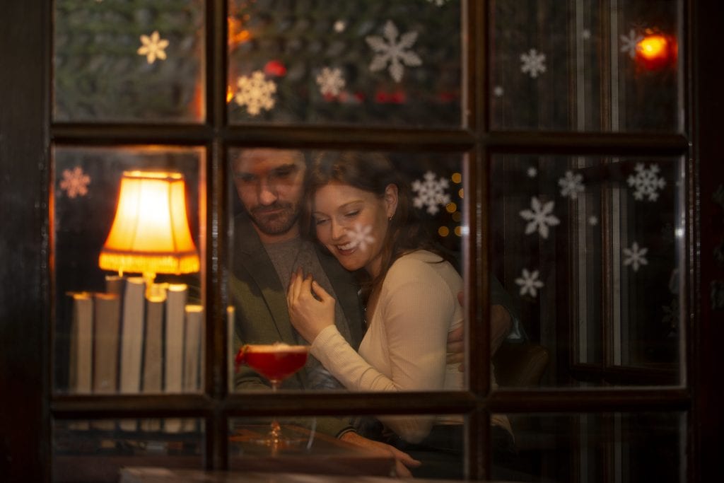 Cozy home scene at dusk showing a couple connecting, symbolizing a home that has been intentionally designed to pull them together, not apart.