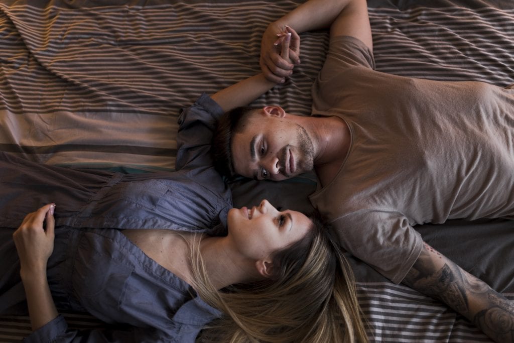 Married couple sharing a small bedtime window for conversation, showing how Pre-Deciding Your Evenings can transform the final minutes of the day into closeness.