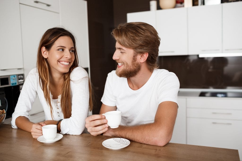 Husband and wife smiling gently at each other over coffee, capturing the quiet wins you celebrate when you Celebrate the Quit